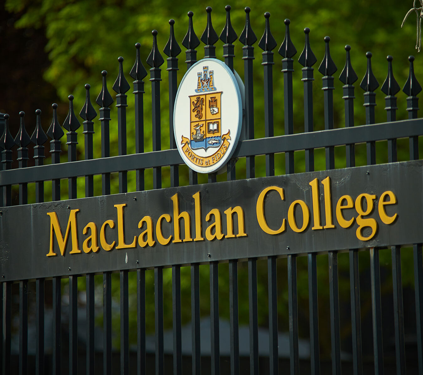 Close up of MacLachlan College crest on the shool's main gate.